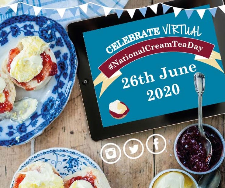 iPad saying celebrate virtual national cream tea day on wooden table surrounded by cream tea and party decorations
