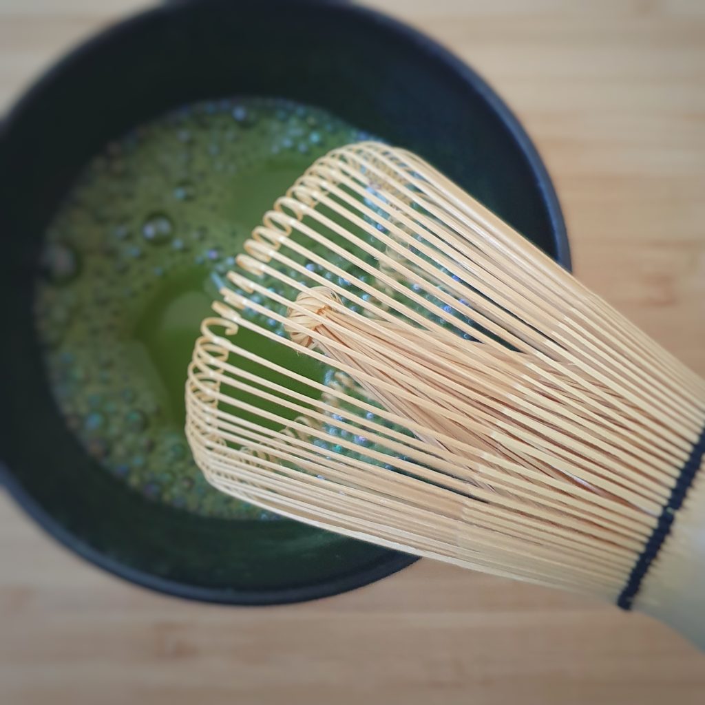 Matcha in teabowl with whisk