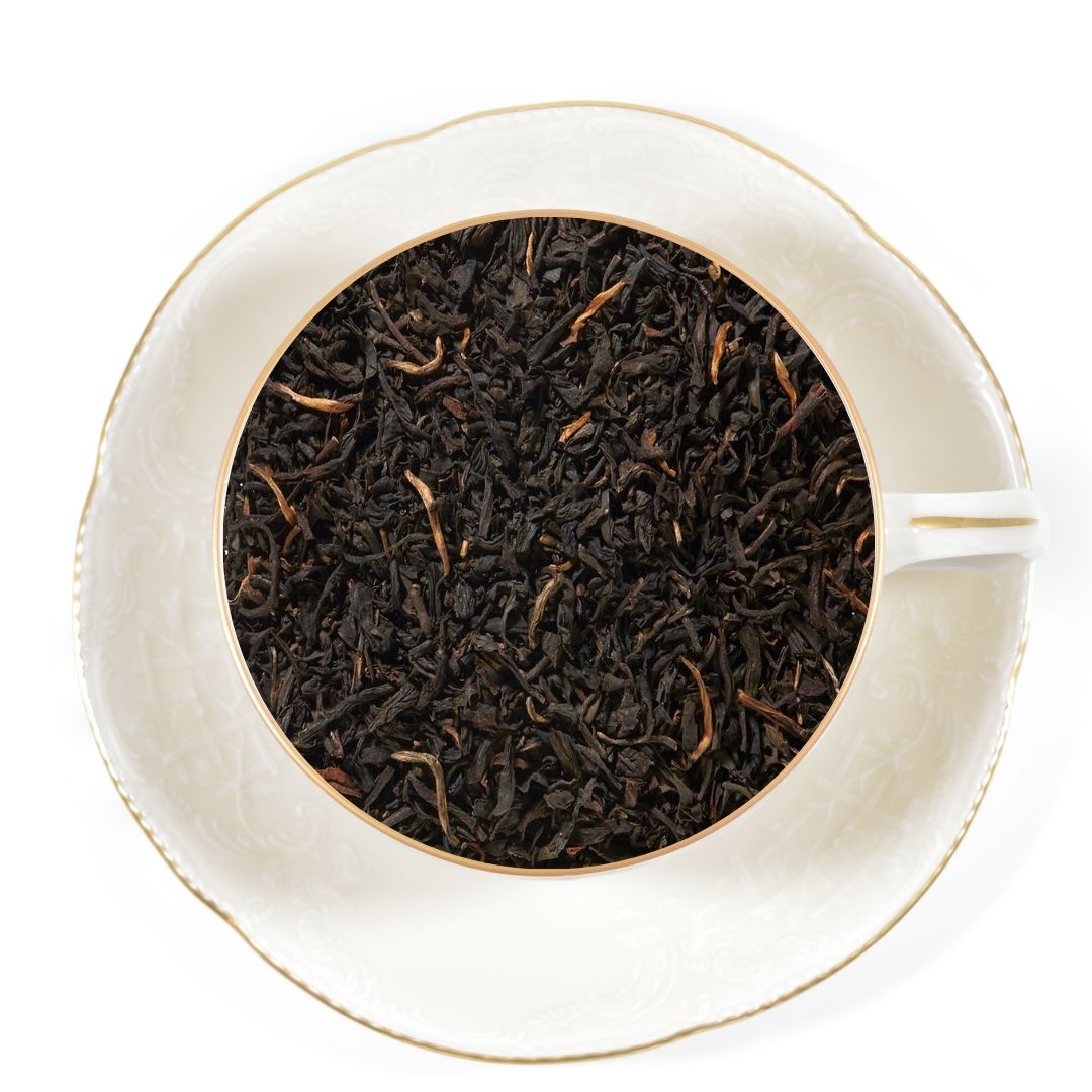 caravan blend tea leaves in white tea cup