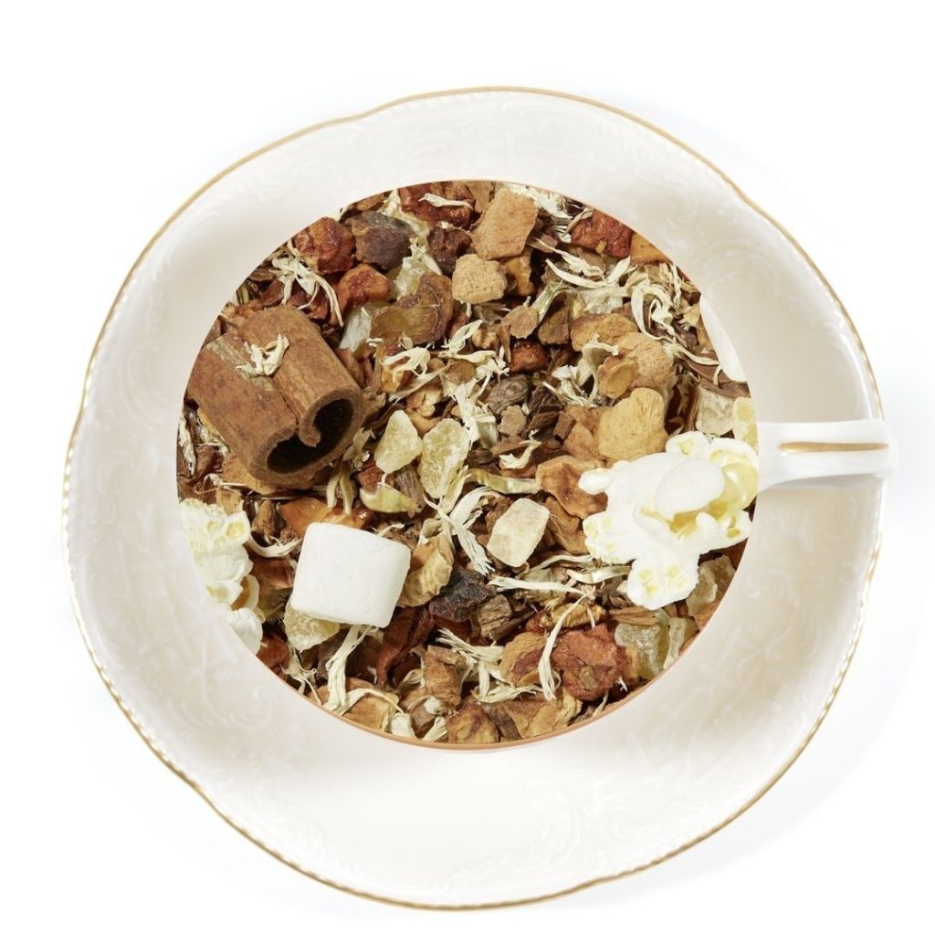 a white cup tea cup and saucer filled with cinnamon cloud herbal infusion tea